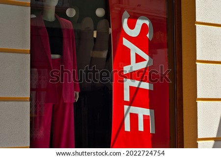 Banner for advertising in a shop window. Sign Board behind the glass. Inscription sale on a black banner.