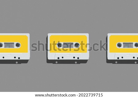 Pattern of audio cassette with copy space. Vintage white audio cassette tap on colored background. Old cassette tape audio isolated.
