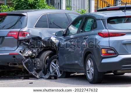 Car crashed into parked car on neighborhood street Royalty-Free Stock Photo #2022747632