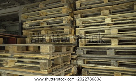 Wooden Euro pallets for the transfer of goods to customers. Used wooden pallets are available in stock. Overlapping of a wooden pallet. Camera movement. Logistics and loading.