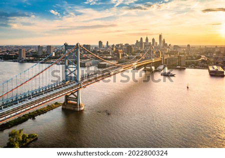 Aerial view of Ben Franklin Bridge and Philadelphia skyline at sunset. Ben Franklin Bridge is a suspension bridge connecting Philadelphia and Camden, NJ.