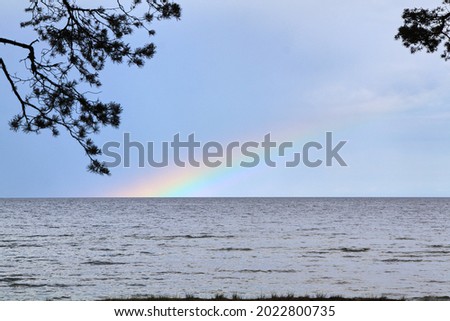 Rainbow in the sea on a stormy day. High quality photo. Selective focus