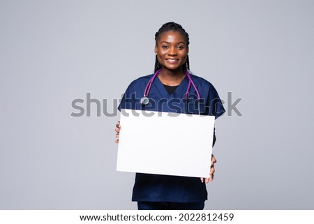 African doctor woman, medical professional working holding blank advertising banner, good poster for ad, offer or announcement, paper billboard isolated on white background