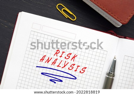 Financial concept about RISK ANALYSIS with sign on the page. Risk analysis is the study of the underlying uncertainty of a given course of action
