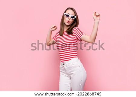 Photo of young excited girl happy positive smile have fun dance wear sunglass isolated over pink color background