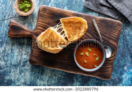 Top down view of a grilled cheese sandwich with tomato soup, ready for eating. Royalty-Free Stock Photo #2022880796