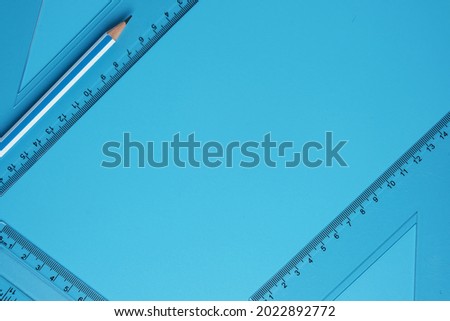 A picture of geometry set with sticky note on copyspace blue background. Mathematics and engineering concept