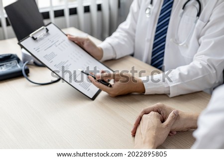 The doctor is explaining the details of the patient's physical examination. The concept of annual physical examination for healthy health care and timely disease detection and treatment. Royalty-Free Stock Photo #2022895805