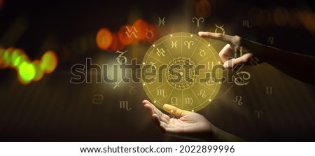 Human predicts the future. Astrology zodiac sign horoscope wheel of fortune hologram with mandala inside and abstract background. Power of the moon and the Universe.