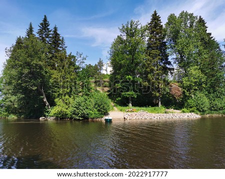 View from the shore of the Vyborg Bay to the island with a Chapel and a grotto in the Monrepos rock Natural Park of the city of Vyborg.
