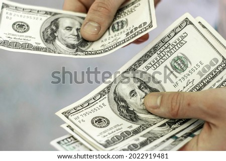a man counts money a bundle of hundred dollar bills. High quality photo