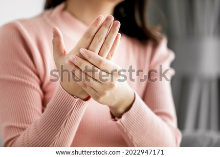 Close up of Young women massaging palm suffering pain inflammation, Trigger finger, Office Syndrome, Health Care Concept. Royalty-Free Stock Photo #2022947171