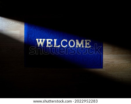 Welcome on the doormat with light and shadow