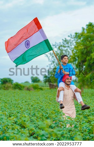 young indian farmer and his child with indian flag Royalty-Free Stock Photo #2022953777
