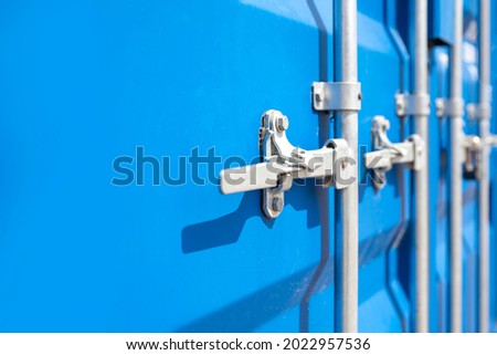 Container close-up. Blue cargo container with a lock. The concept of the increased cost of freight. Banner with place for text.