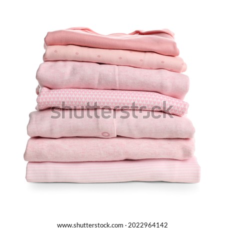 Stack of baby girl's clothes on white background