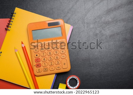 Flat lay composition with school stationery on blackboard, space for text
