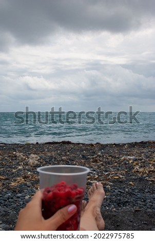 Rest at the sea. Raspberries. Volcanic sand. 