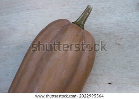 A big pumpkin on a wooden table
