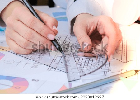 Hands use pencil with a protractor. Architectural Project drawings with tools. Architects workplace. Engineering Interior designer's working table