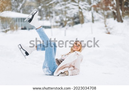 Young woman on the ice after a fall.
