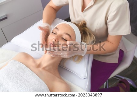 Woman undergoing cosmetic procedure in beauty salon Royalty-Free Stock Photo #2023043897