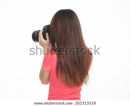 Asian female photographer making pictures, back view, isolated on white.