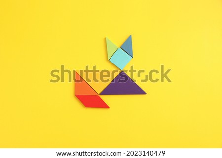 Wooden blocks cat isolated in yellow background
