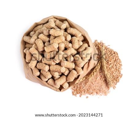 Granulated wheat bran in bag and spikelets on white background, top view