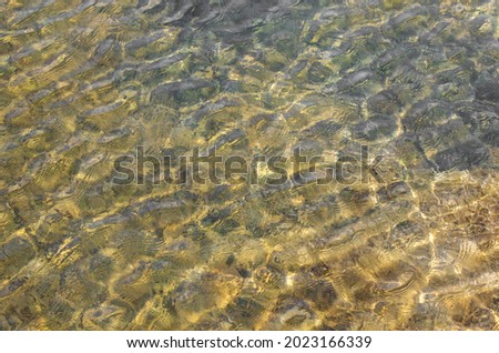 small waves on the surface of clear water