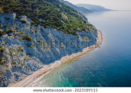 Coastline with sea and rocky cliff. Summer day on sea. Aerial view