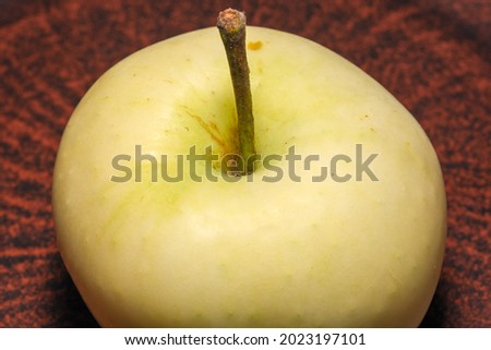 Fruit picture white ripe sweet apple on a brown clay plate close-up macro photography