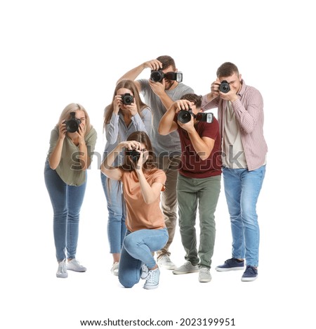 Group of young photographers on white background