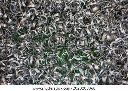 Closeup machined steel  twisted spiral steel in tank shavings industry