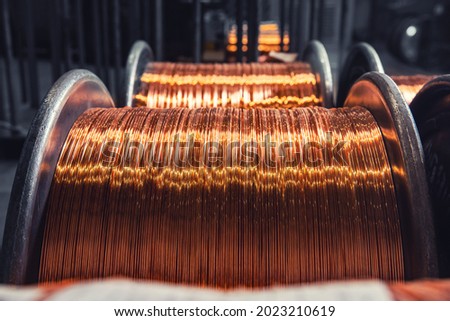 Copper wire cable production in coils, metal steel industrial plant. Royalty-Free Stock Photo #2023210619