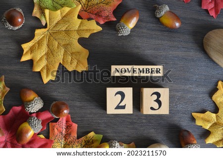 November 23, Cover Date design with Calendar cube decorate with maple leaf and Acorn Oak seed for your business.