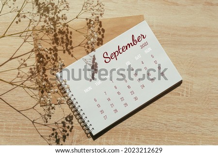 September 2021. Calendar for full month. Notebook for writing on spring next to a sprig of gypsophila flowers. Autumn month. Concept of time planning. Royalty-Free Stock Photo #2023212629