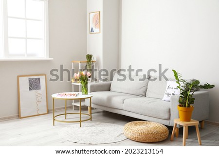 Bouquet of tulip flowers on table in interior of living room