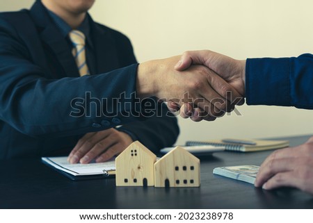 House developers agent or financial advisor and customers shaking hands after signing document making deal as successful agreement, contract with a firm.
