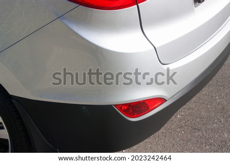 Rear bumper corner of a stylish silver vehicle Royalty-Free Stock Photo #2023242464