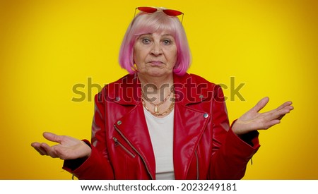 I dont know what to say. Confused mature old rocker granny grandmother feeling embarrassed about ambiguous question, having doubts no idea, being clueless and uncertain. Senior emo woman studio shot