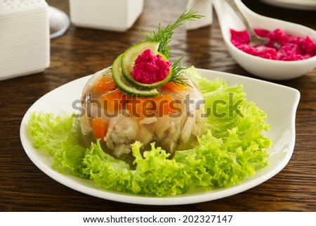 meat jelly with vegetables and sauce.