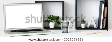 Home office. Homework. Black square shelves. Succulents as decoration. White wall copy space. Open laptop. Mockup. Banner. Panorama.