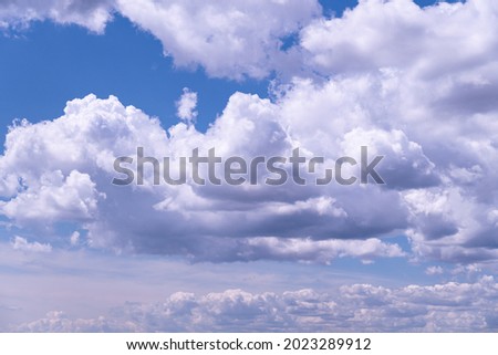 Cloudy fluffy sky natural background. Blue and white cloudscape.  Transition of gently cloud scape at summer day. Clean of birds, bugs, and dust.