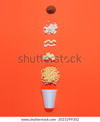 Mexican snack, two trolley, prepared esquite, corn in a cup, with chili powder on orange background, no people Royalty-Free Stock Photo #2023299302