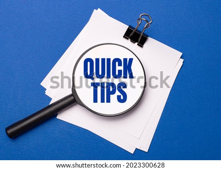 On a blue background, white sheets under a black paper clip and on them a magnifying glass with the text QUICK TIPS