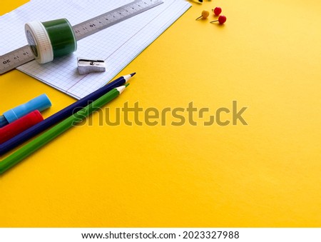 School supplies on yellow background top view. Creative frame layout with school stationery. Flat lay. Colored stationery. Isolated background.  Copy space.  Back to school