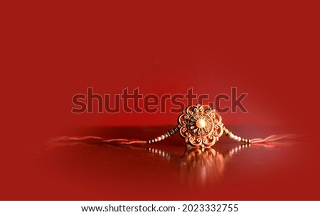 Raksha Bandhan background with an elegant Rakhi. A traditional Indian wrist band which is a symbol of love between Brothers and Sisters Royalty-Free Stock Photo #2023332755