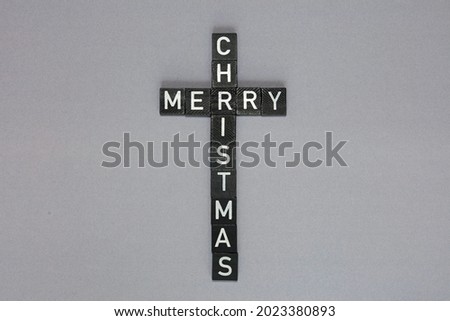 Letters On Wooden Blocks Spelling Out Merry Christmas In The Shape Of A Cross.