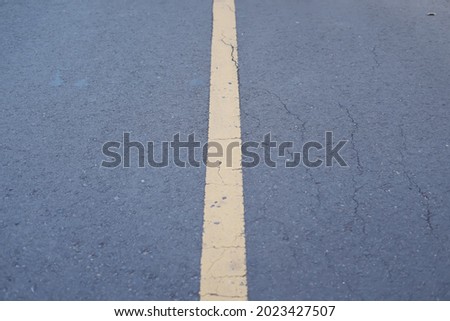Yellow road marking line on asphalt